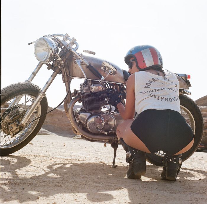 A playful frame from Girls on a motorcycle — online in Singapore